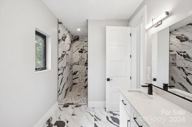 bathroom featuring vanity and a tile shower