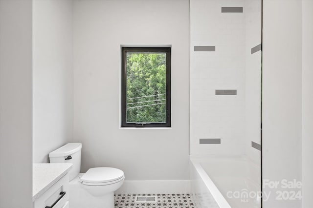 full bathroom with toilet, vanity, and tiled shower / bath combo