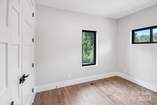 unfurnished room with light wood-type flooring