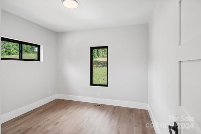 unfurnished room featuring hardwood / wood-style floors