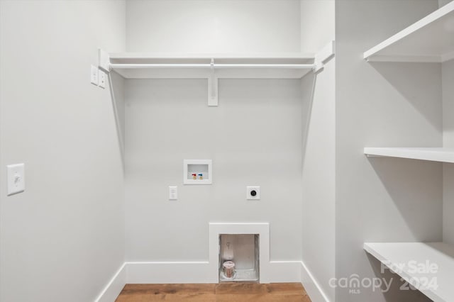 clothes washing area featuring hookup for a washing machine and hookup for an electric dryer