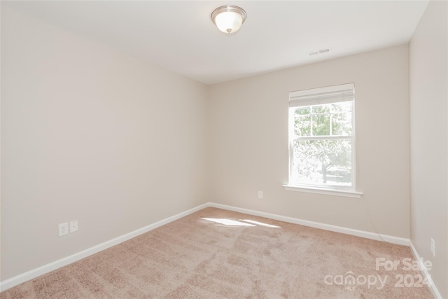 empty room featuring light carpet