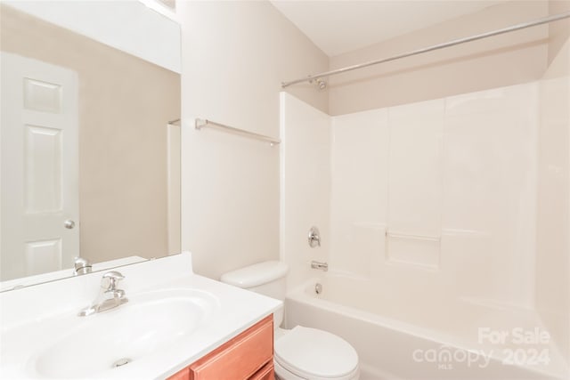 full bathroom featuring vanity, bathing tub / shower combination, and toilet