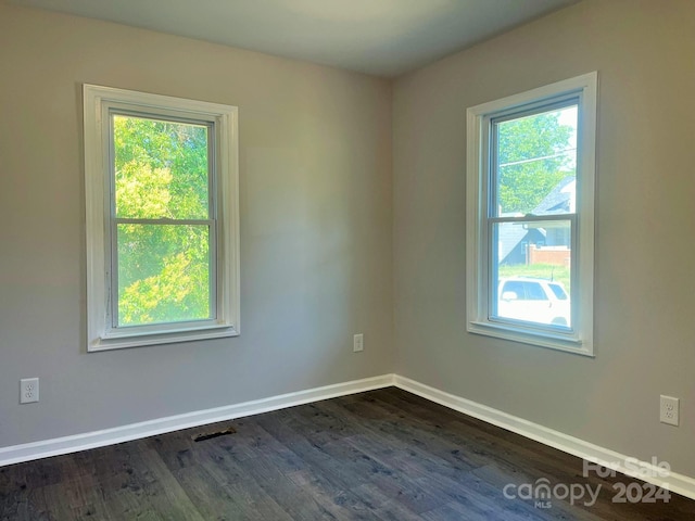 spare room featuring dark hardwood / wood-style flooring