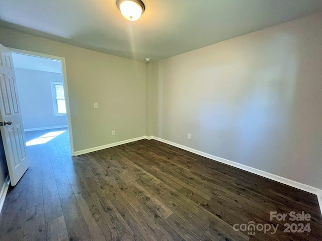 spare room with dark hardwood / wood-style flooring