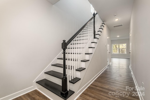 staircase featuring hardwood / wood-style floors