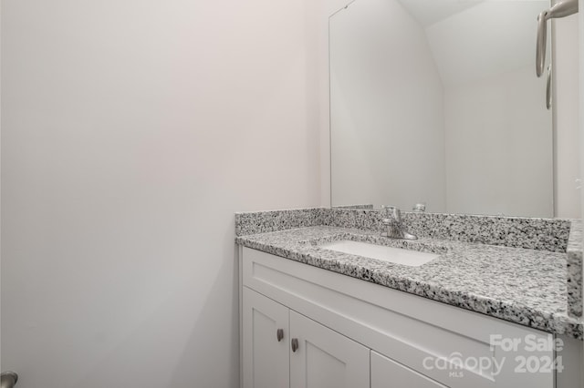 bathroom featuring vanity and vaulted ceiling