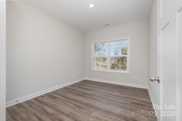 empty room with dark hardwood / wood-style flooring