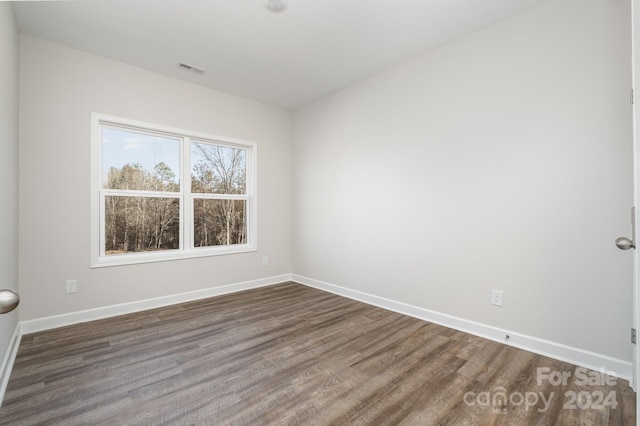 spare room featuring dark hardwood / wood-style flooring