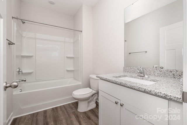 full bathroom featuring shower / bathtub combination, vanity, toilet, and hardwood / wood-style floors