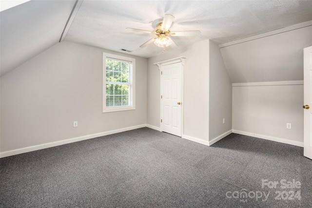 additional living space with lofted ceiling, a textured ceiling, carpet floors, and ceiling fan