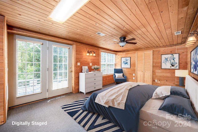 bedroom featuring wood ceiling, wood walls, ceiling fan, carpet flooring, and access to exterior