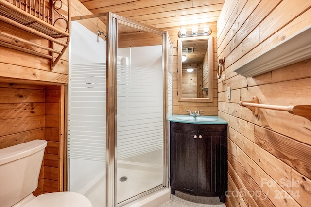 bathroom featuring wood ceiling, wood walls, toilet, vanity, and a shower with door