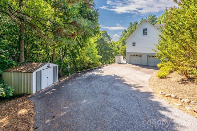 view of home's exterior with a garage and a shed