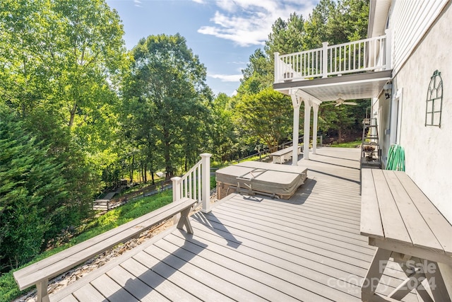 deck featuring ceiling fan and a covered hot tub