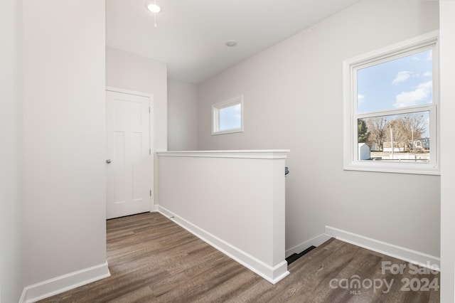 hallway with dark hardwood / wood-style flooring