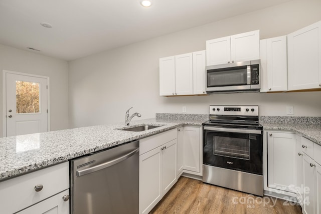 kitchen featuring sink, white cabinets, and stainless steel appliances