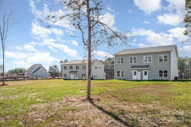 rear view of house with a yard