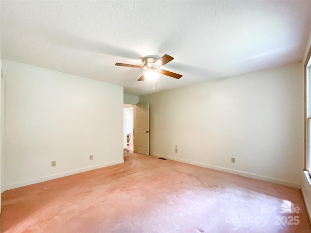 empty room with ceiling fan and light colored carpet