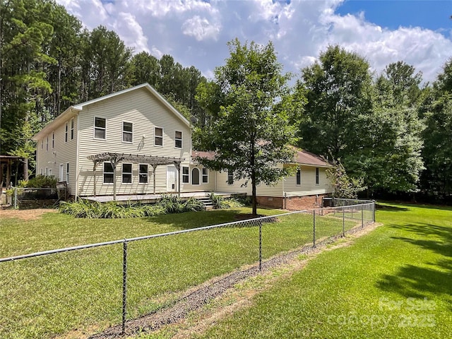 view of front facade with a front yard and a deck