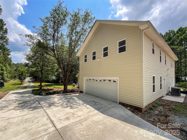 view of property exterior featuring central AC and a garage