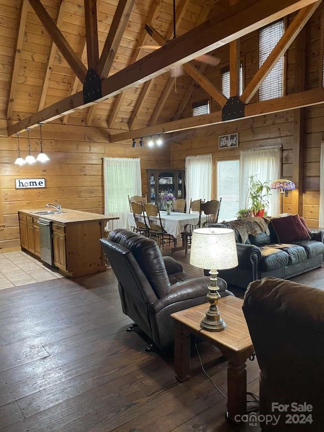 living room with wooden walls, high vaulted ceiling, hardwood / wood-style floors, beam ceiling, and wood ceiling