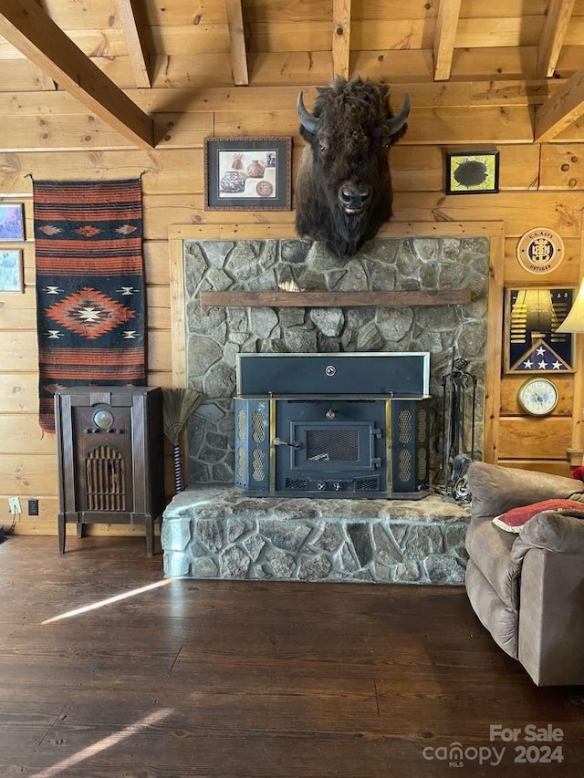 living room featuring a fireplace, wooden walls, and wood-type flooring