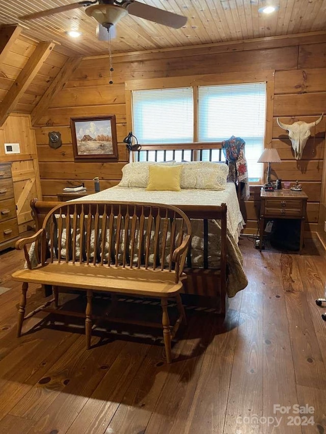 bedroom with wooden walls, vaulted ceiling, hardwood / wood-style floors, wood ceiling, and ceiling fan