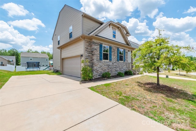 view of front of property with a garage and a front lawn