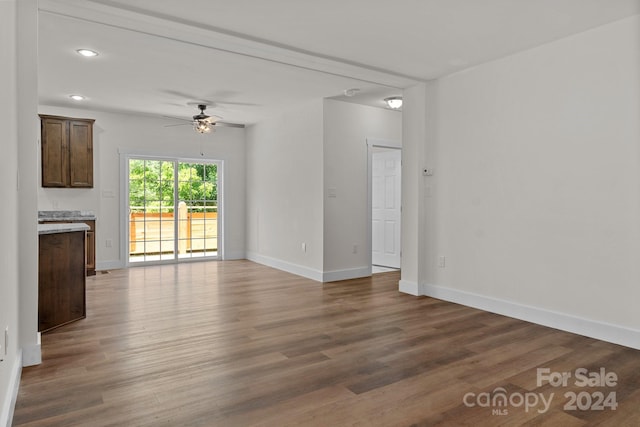 unfurnished living room featuring ceiling fan and hardwood / wood-style floors