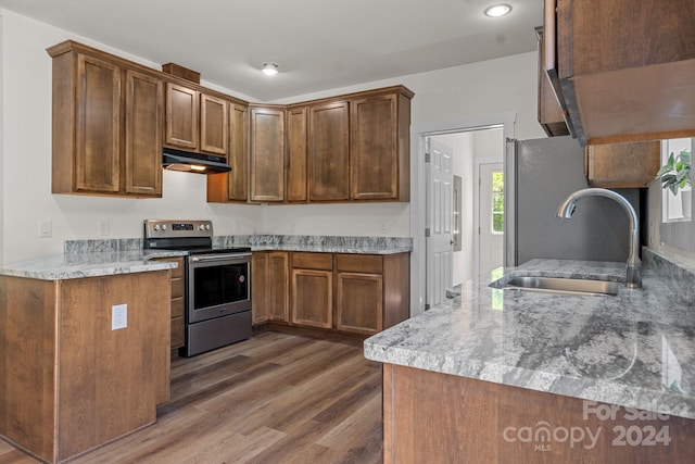 kitchen featuring light stone countertops, dark hardwood / wood-style flooring, sink, and electric stove