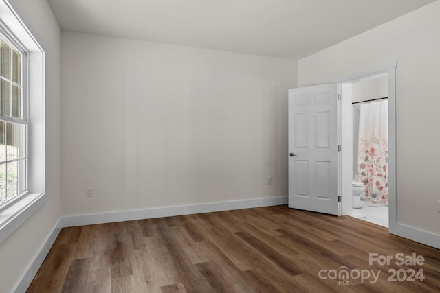 spare room with dark wood-type flooring