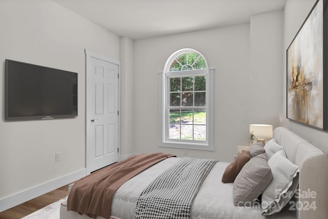 bedroom with hardwood / wood-style floors