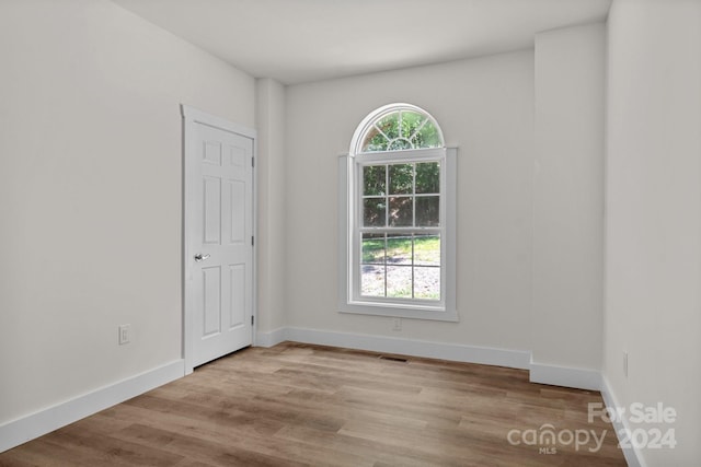 spare room with light hardwood / wood-style floors