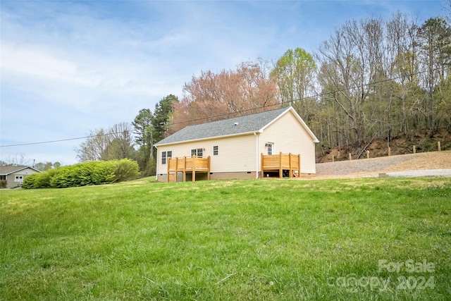 back of house with a lawn and a wooden deck