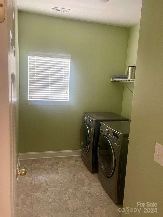 laundry area featuring washing machine and clothes dryer