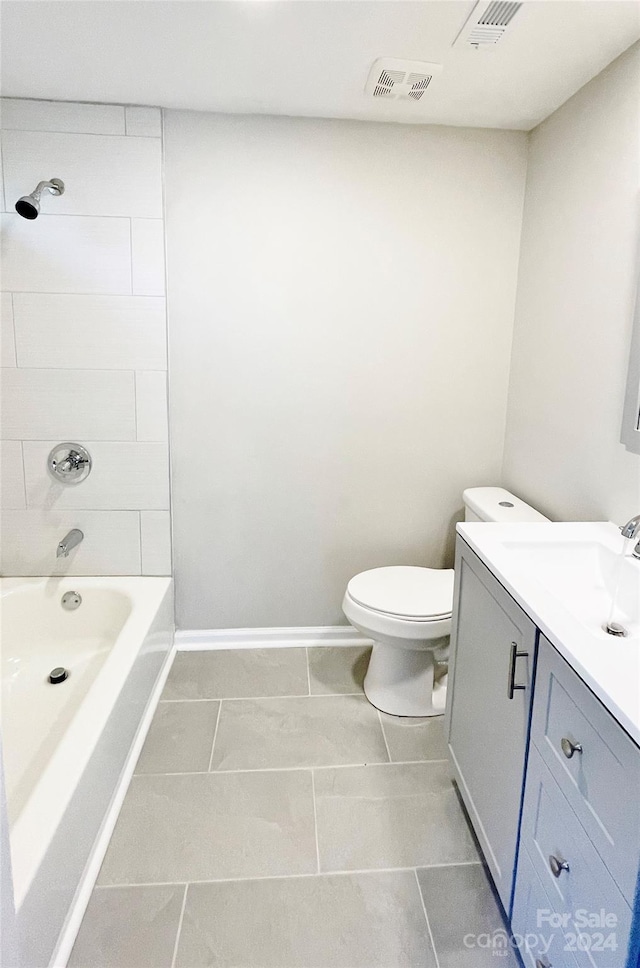 full bathroom with toilet, vanity, and tiled shower / bath