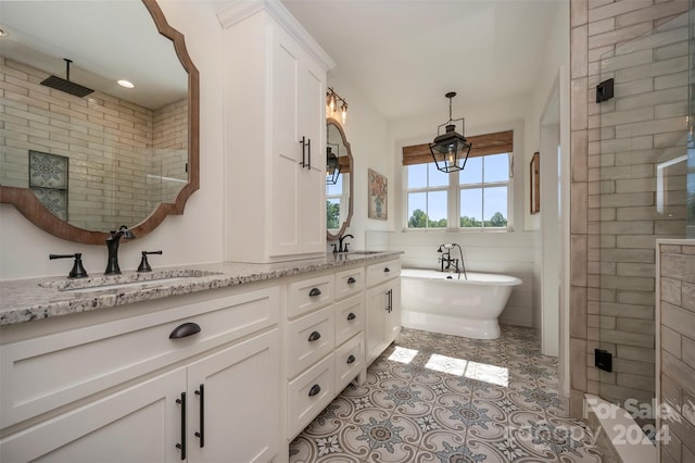 bathroom featuring tile patterned floors, vanity, and separate shower and tub