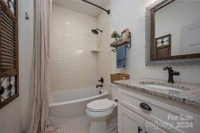 full bathroom with shower / bath combo with shower curtain, tile patterned floors, toilet, and vanity