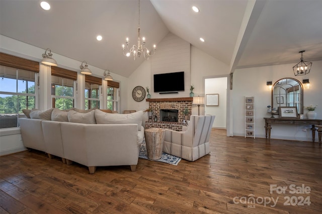 living room featuring a notable chandelier, dark hardwood / wood-style flooring, a fireplace, and high vaulted ceiling