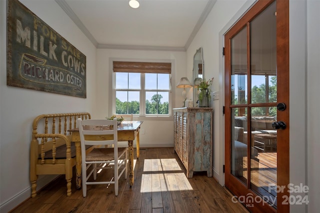 dining area with dark wood-type flooring and ornamental molding