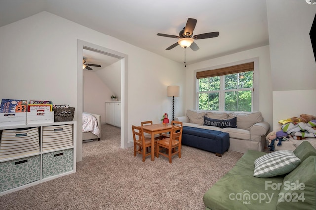 living room featuring ceiling fan, light colored carpet, and vaulted ceiling