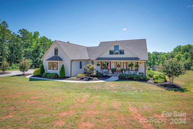 view of front of house with a front yard and covered porch