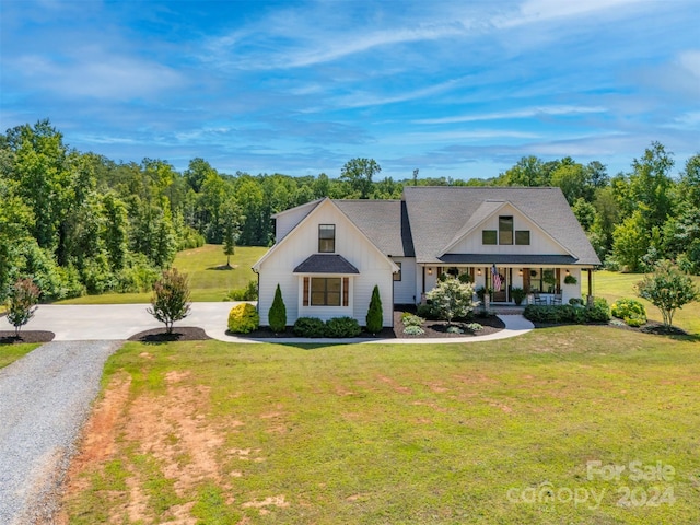 view of front of home featuring a front yard and covered porch