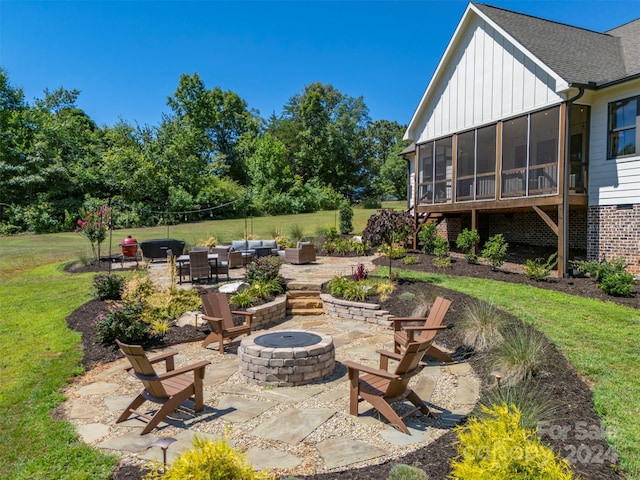 view of patio with an outdoor living space with a fire pit and a sunroom