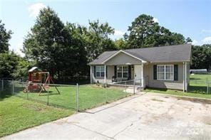 view of front of property featuring a playground and a front lawn