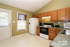 kitchen featuring sink, white appliances, ventilation hood, and lofted ceiling