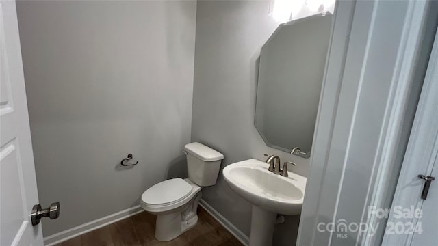 bathroom featuring hardwood / wood-style flooring, toilet, and sink