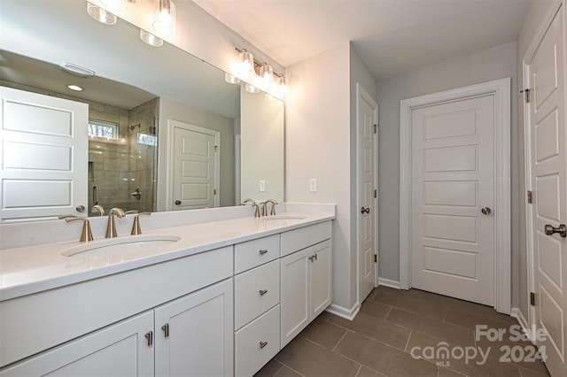 bathroom with tile patterned floors, vanity, and an enclosed shower