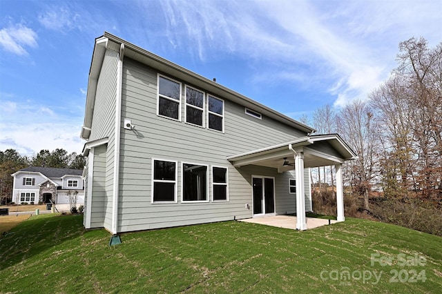 back of house with a yard, ceiling fan, and a patio area